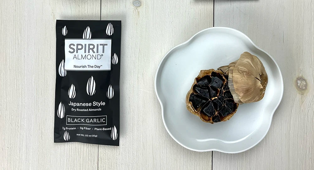SPIRIT Almond Package next to a head of black garlic
