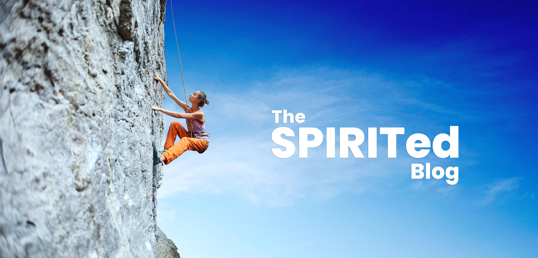 SPIRIT Almond Blog - The SPIRITed Blog, image showing a woman climbing a rock face against a blue sky