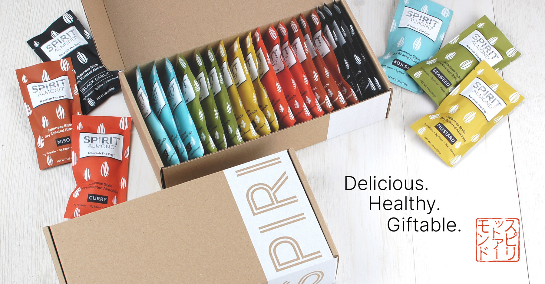 SPIRIT Almond Gift Box, Kraft color, with white band showing SPIRIT logo, Japanese-flavored multi-colored individual packages. Titles: "Delicious, Healthy, Giftable."