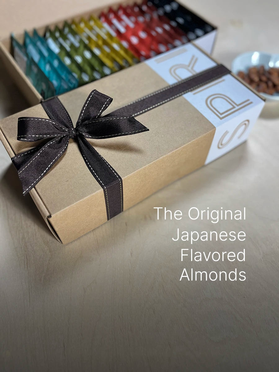 Gift Box of SPIRIT Almond with tied ribbon, open box display showing colorful packaging, and plate of almonds