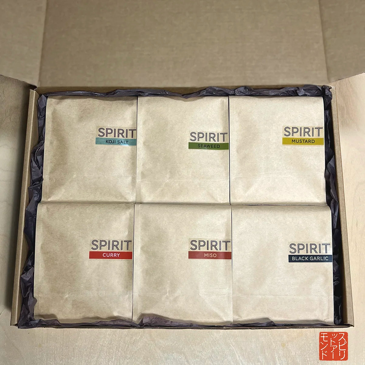 SPIRIT Almond MEGA Pack with six pouches as seen inside gift box with brown tissue paper