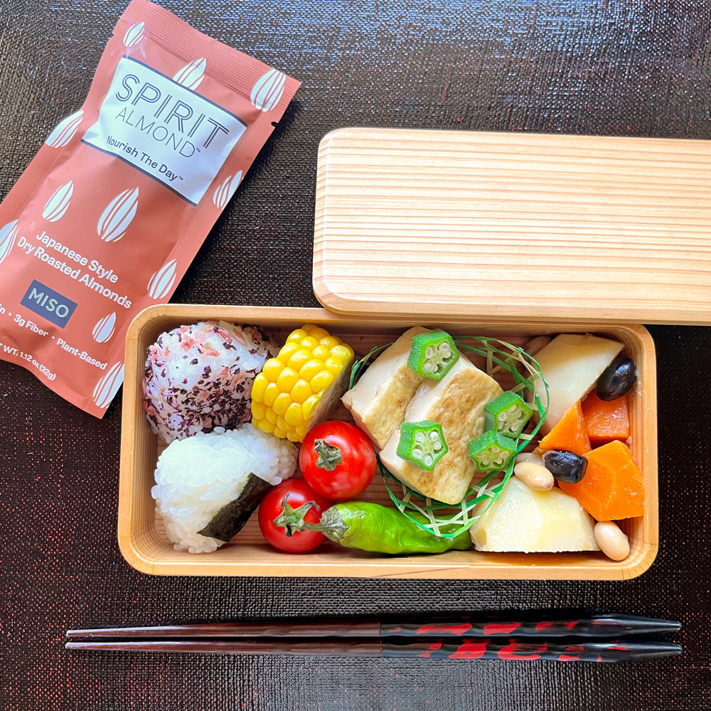 SPIRIT Almond Miso flavor in package next to a Japanese style lunchbox