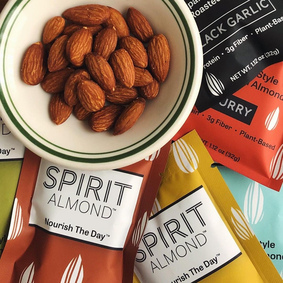 SPIRIT Almond packages around a plate of unpackaged SPIRIT Almond.